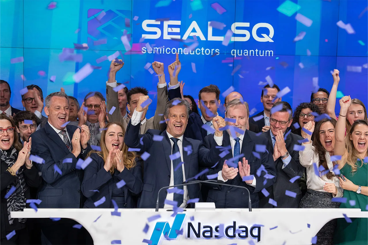 The SEALSQ team on the Nasdaq MarketSite podium under a SEAL SQ screen, applauding as confetti falls.
