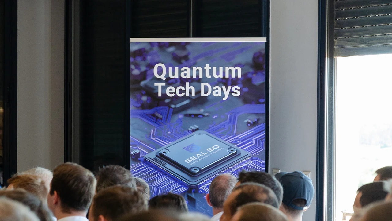 A seated audience facing a Quantum Tech Days banner showing a SEAL SQ chip on a circuit board.